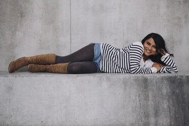 Female Indian laying on concrete wall - GCF000225