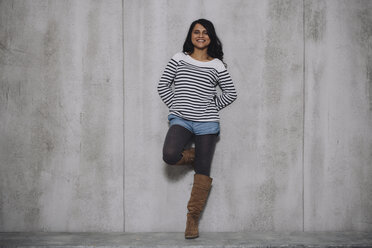 Female Indian leaning on concrete wall - GCF000226