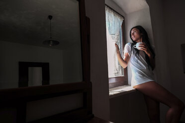Woman drinking coffee, at window - SIPF000660