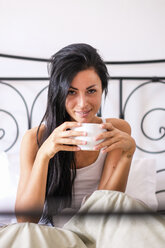 Woman drinking coffee in bed - SIPF000668