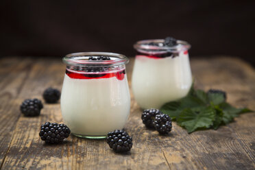 Two glasses of natural yoghurt with sirup and blackberries - LVF005135