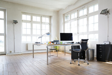 Desk and chair in bright office - FKF001924