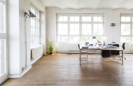 Desk and chair in bright office - FKF001929