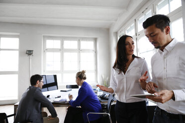 Group of business people discussing in office - FKF001936