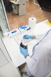 Laboratory technician in analytical laboratory preparing samples for analysis - ABZF000860