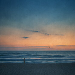 Silhouette of man on the beach at sunset - DWIF000763