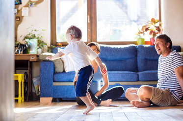 Father and pregnant mother playing with son at home - HAPF000628