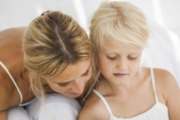 Mother and little daughter watching something - TCF005008