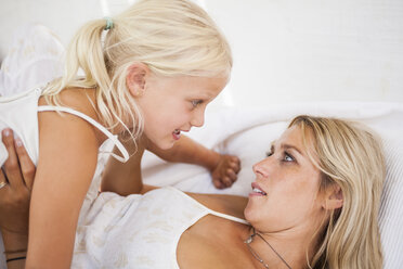Mother and little daughter talking together - TCF005016