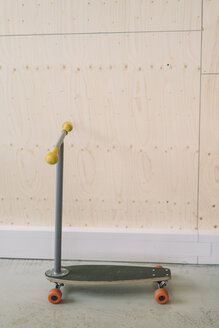 Büro-Skateboard vor einer Holzwand - RIBF000501