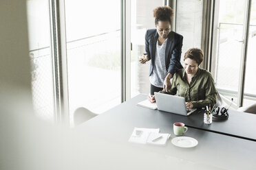 Two businesswomen in an office - UUF008254