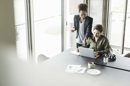 Two businesswomen in an office - UUF008254