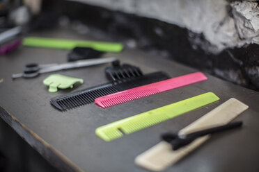 Combs and equipment laid out on table at barbershop - ZEF009214