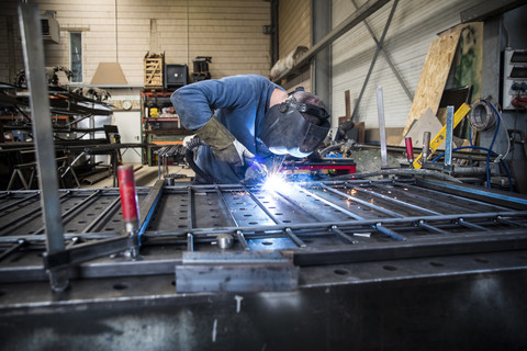 Metal construction, welder welding railing stock photo
