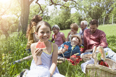 Girl with watermelon at a family picnic in meadow - RBF004785