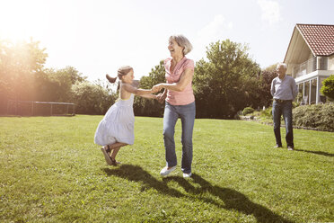 Playful grandmother with granddaughter in garden - RBF004792