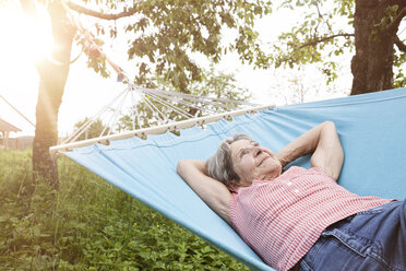 Senior woman relaxing in hammock - RBF004824
