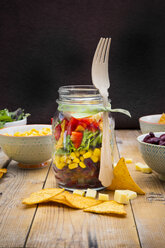 Glass of Tex-Mex salad and ingredients on wood - LVF005165