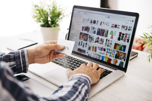 Man with laptop and credit card shopping online, partial view - JRFF000784