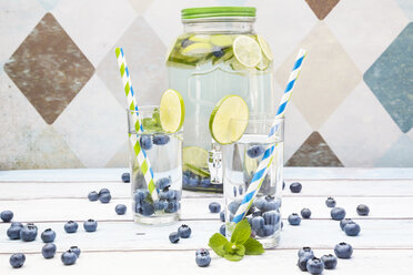 Glasses of infused water with lime, blueberries and mint - LVF005173