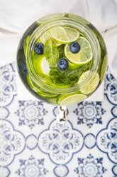 Glass of infused water with lime, blueberries and mint - LVF005175