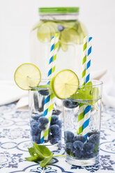 Glasses of infused water with lime, blueberries and mint - LVF005178