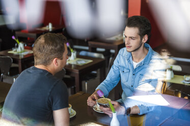 To men socializing in a cafe - DIGF000787