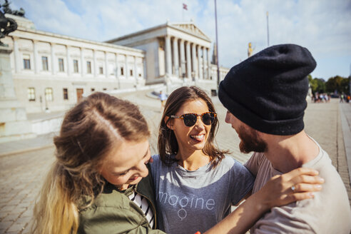Austria, Vienna, three friends having fun in front of the parliament building - AIF000352