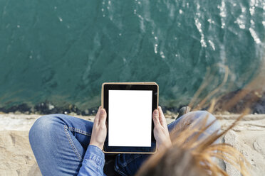 Young woman sitting on dock using digital tablet - BOYF000486