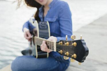 Young woman at the waterfront playing guitar - BOYF000500