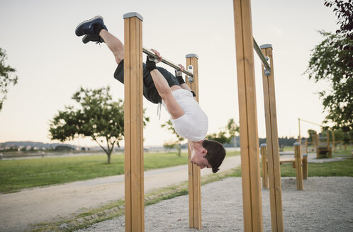 Sportler, Mann, Training an einer Metallstange, im Freien - RAEF001323