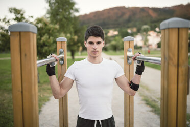 Portrait of a young man, ready to train on a metall bars - RAEF001324