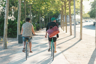 Two men riding bike - SKCF000126