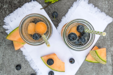 Two carafes of infused water with blueberries and melon - SARF002828