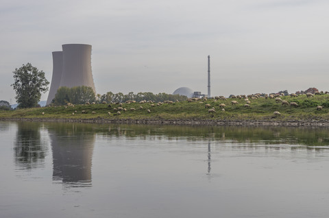 Germany, Lower Saxony, Grohnde, Grohnde Nuclear Power Plant and flock of sheep stock photo