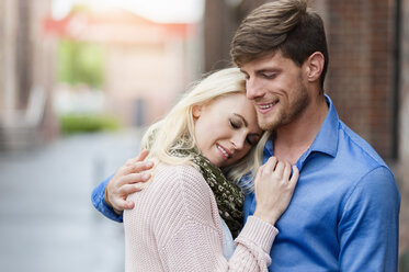 Happy couple hugging outdoors - DIGF000870