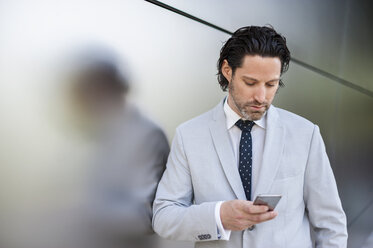 Businessman looking at smartphone - DIGF000892