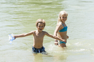 Little boy and his sister bathing in a river - TCF005027