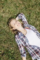 Young woman relaxing on a meadow - GIOF001361