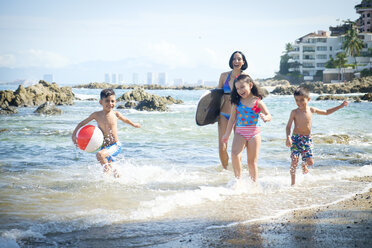 Mexico, Puerto Vallarta, mother and three children having fun at seafront - ABAF002065
