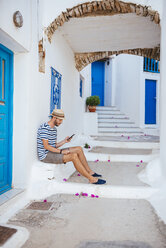 Griechenland, Insel Amorgos, junger Mann benutzt ein Smartphone - GEMF000947