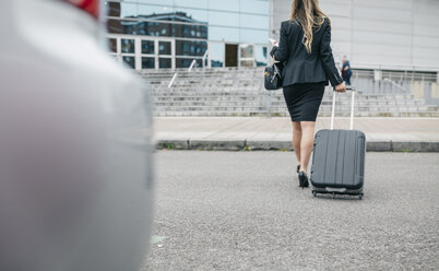 Businesswoman with suitcase on the move - DAPF000205