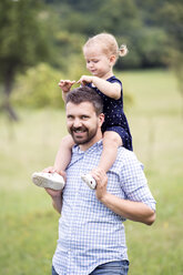 Glücklicher Vater trägt kleine Tochter auf den Schultern in der Natur - HAPF000699