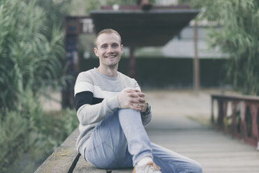 Portrait of smiling man on a bridge - SKCF000154