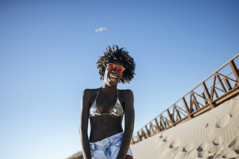 Happy young woman on the beach stock photo