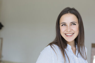 Portrait of smiling young woman - TKF000453