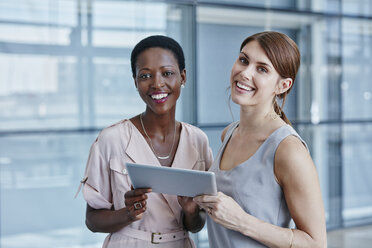 Two businesswomen with digital tablet - RORF000231