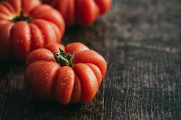 Homegrown organic oxheart tomatoes on dark wood - IPF000323