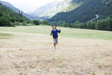 Happy little boy running on a mountain meadow - VABF000745