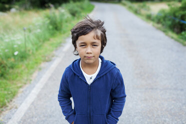 Portrait of little boy standing on a country road - VABF000747